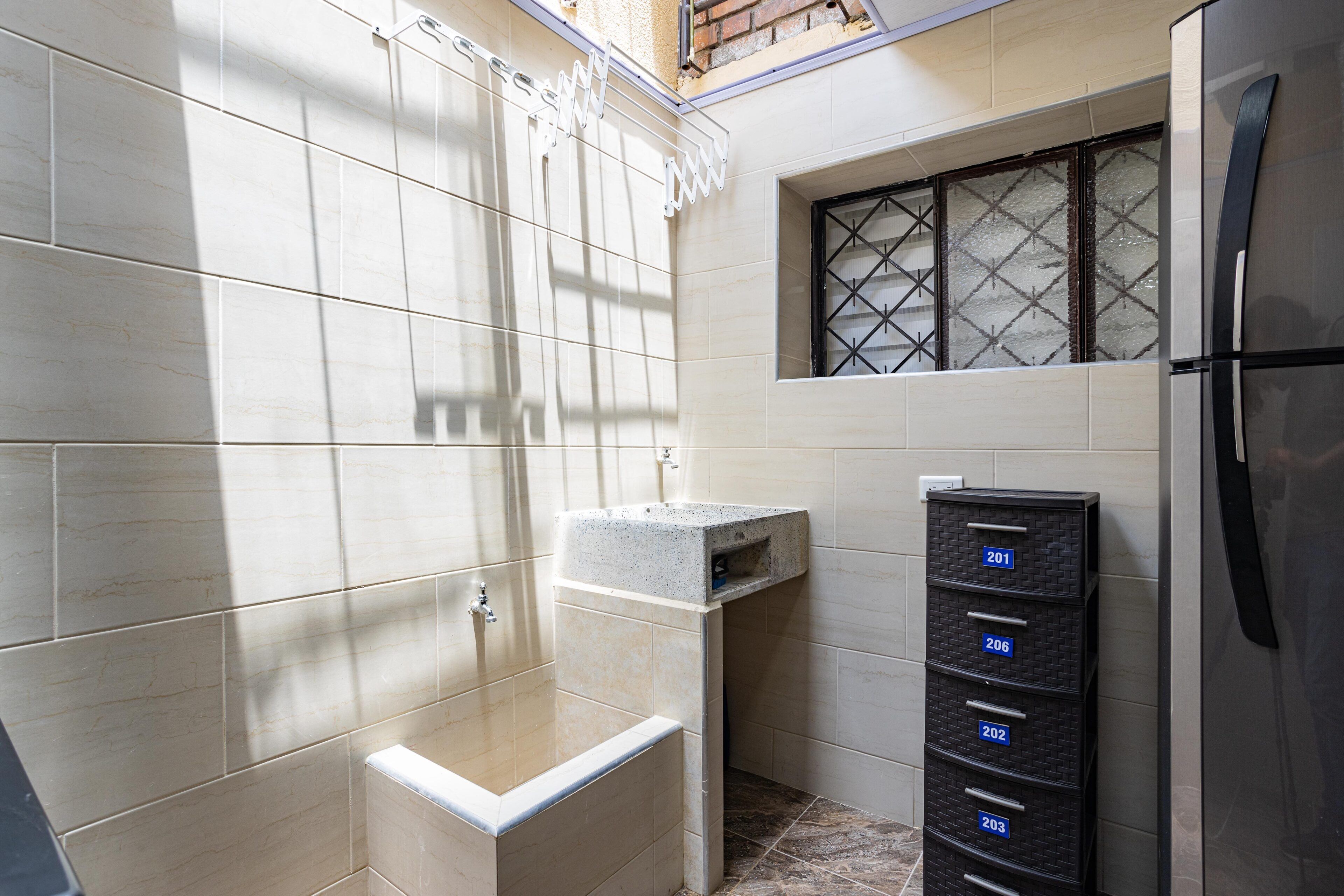 A bathroom with a shower, a sink, and a storage unit with numbered compartments.