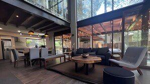 A spacious living area with a dining table, sofas, and a coffee table. - Vacation house with private pool and hottub (Valle de Bravo)