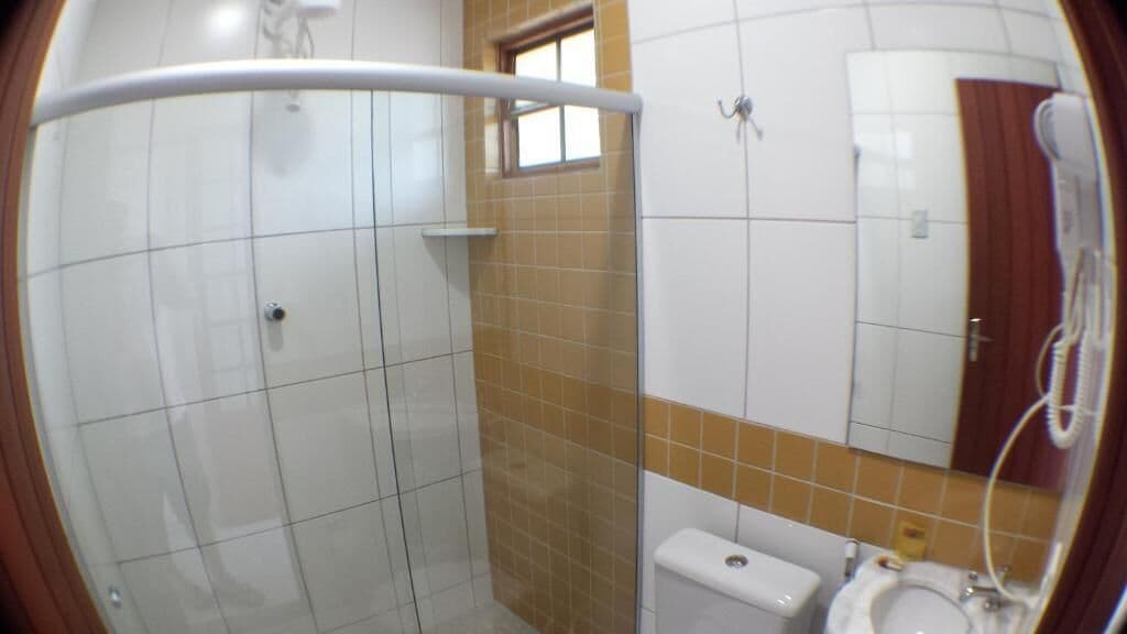 A bathroom with a shower, toilet, and sink.