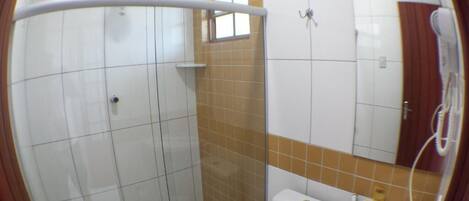 A bathroom with a shower, toilet, and sink.