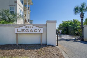 A gated entrance with a sign reading "3880 LEGACY" and a building with balconies. - 🐟Steps to Beach-30A-Legacy 502 Abalone (Santa Rosa Beach)