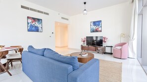 Deluxe Apartment | Living area | 55-inch Smart TV with cable channels, Netflix, streaming services - Luxury StayCation - Huge 2 Bedroom Lav (Dubai)