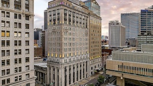 A multi-story building with a classic architectural style, featuring large windows and a prominent entrance. - Downtown Nashville located in Printer's Alley with King Bed! (Nashville)