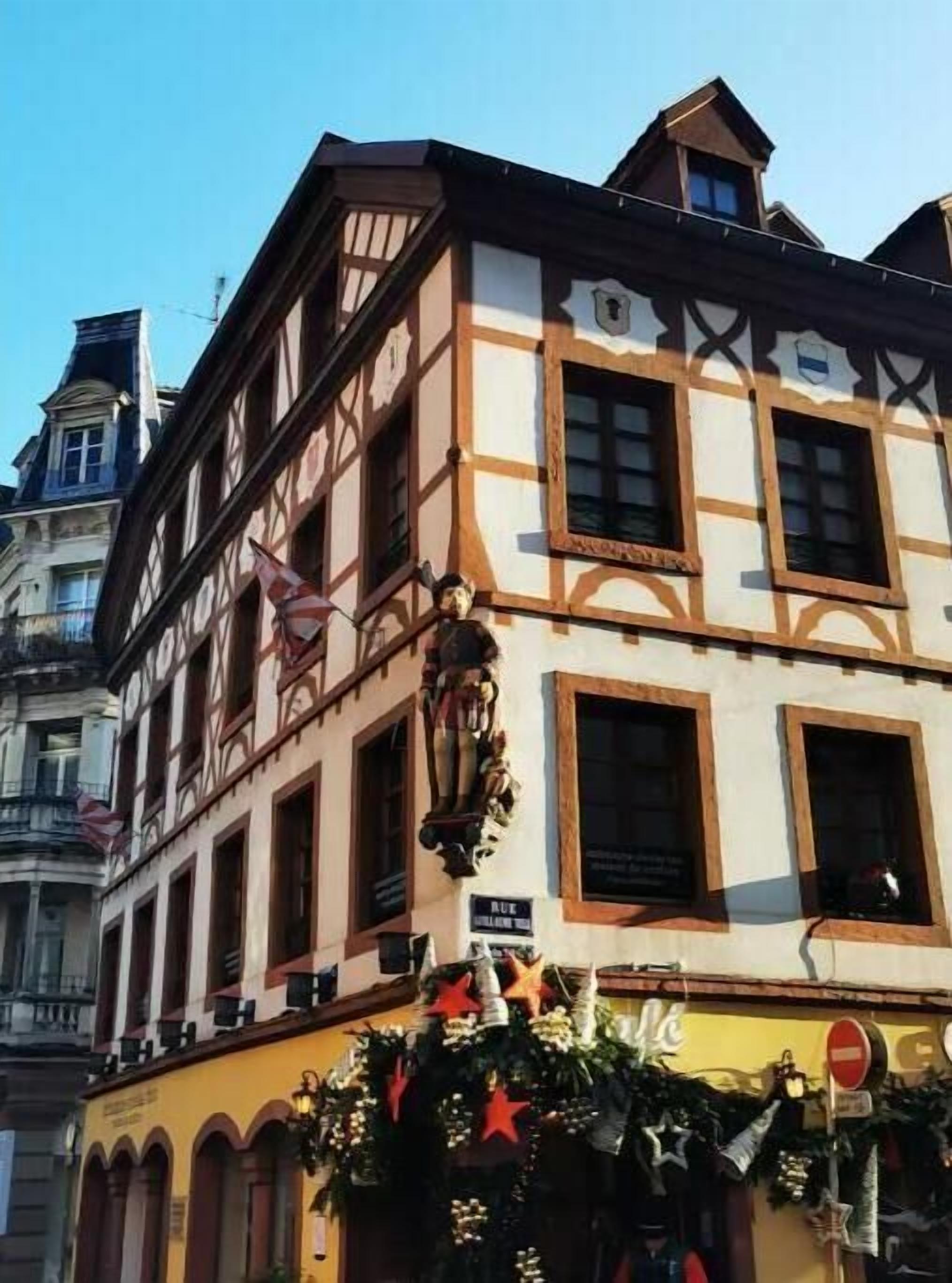A traditional half-timbered building with a sign indicating 'Rue' and 'Maison de la Vieille Dame'.