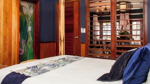A bedroom with a bed, wooden wardrobe, and a built-in shelving unit. - Villas de Isla Bonita  - B2 (San Pedro)