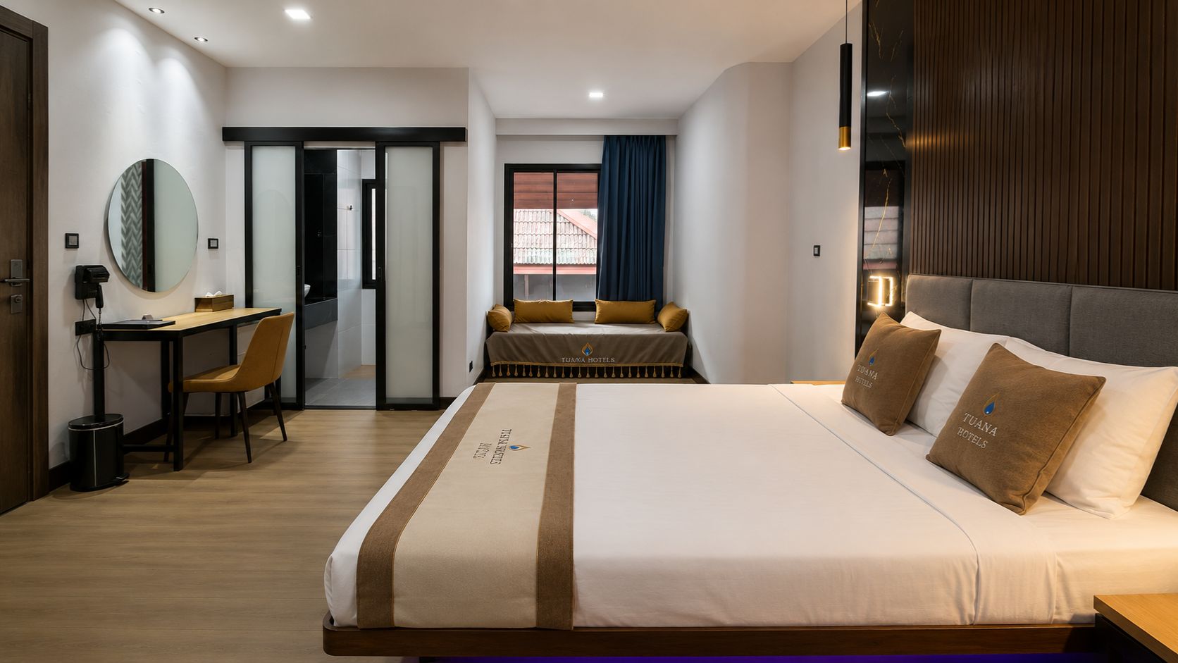 A hotel room with a large bed, a desk, and a view of the outside.