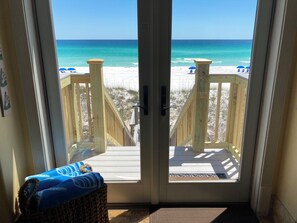 A beach view from a room with a wooden deck and a glass door. - Spiaggia - On the Beach - Gated Community w/Pool - Elevator - Beach Service Incl (Destin)