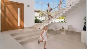 Ein modernes Interieur mit Treppe, einer Holztür und einer Sitzgruppe mit Stühlen.