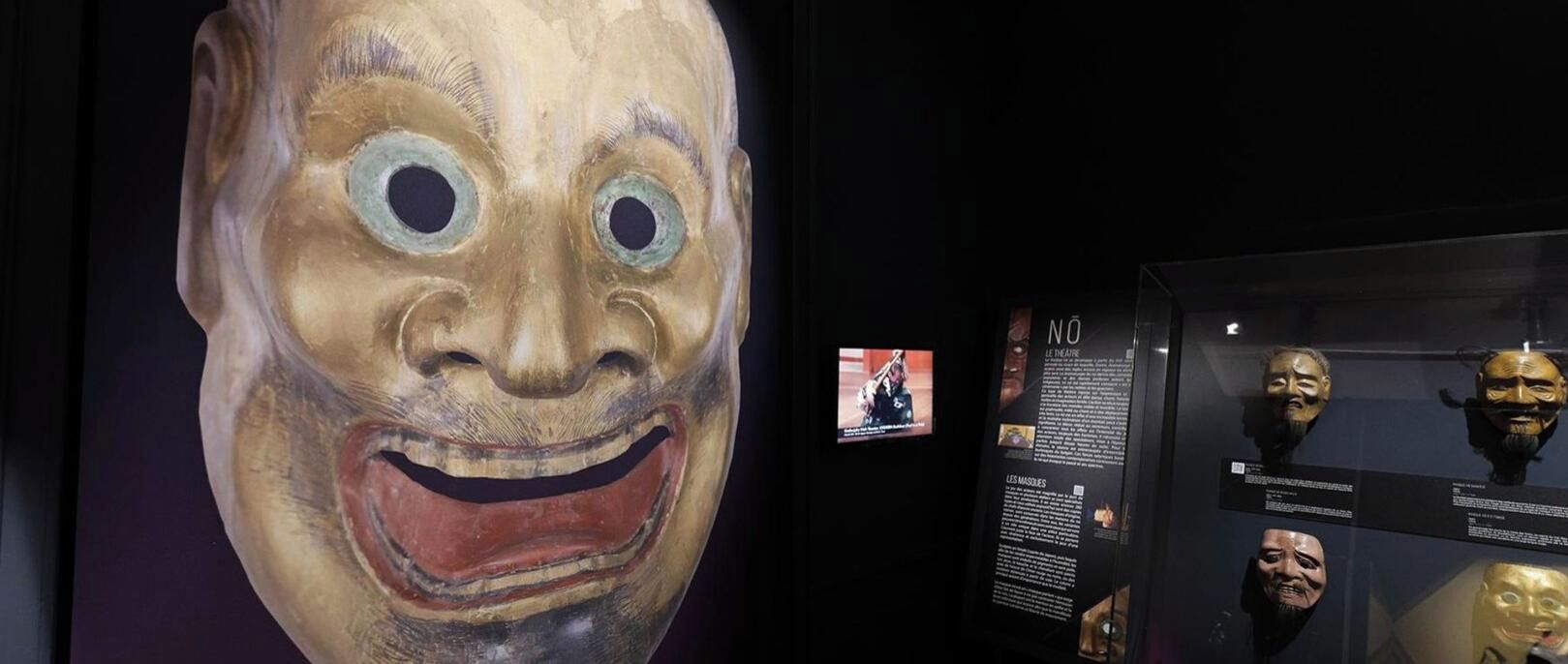 A display of masks with descriptive text panels.