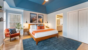 A bedroom with a large bed, a ceiling fan, a window, a chair, and a door leading to a bathroom. - Walk to Beach HotTub FirePit Game room Lake View (East Stroudsburg)