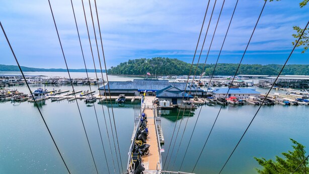 A marina with boats docked, a pier extending into the water, and a building with a blue roof in the background. - Cozy Lake Cumberland Retreat with hot tub, just above Jamestown Marina!


 (Jamestown)