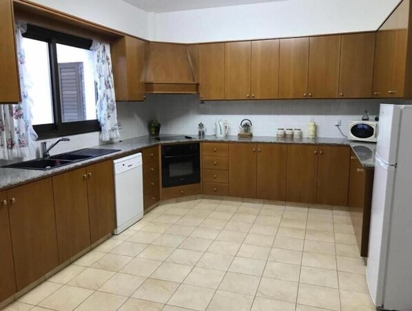 Enjoy cooking in this well-equipped kitchen with a dishwasher and oven, plus a window for natural light.