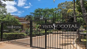 A gated entrance with a sign reading "Vista Ocotal."