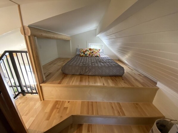 Cozy attic-style bedroom with a single bed and sloped ceiling.