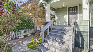 A house with a front porch, steps leading to the door, and a mailbox. - Prime Location walk to attractions w Free Parking (Seattle)