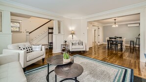 A spacious living room with a sofa, coffee table, and dining area. - Prime Location walk to attractions w Free Parking (Seattle)