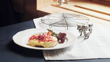 A plate of food on a table with a small figurine of a cow.
