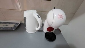 A kitchen with a white kettle and a Nescafé Dolce Gusto coffee machine on a countertop. - KABLAR'S SUNNY SUITES 1BR APT with balcony and sea view (Dubrovnik)