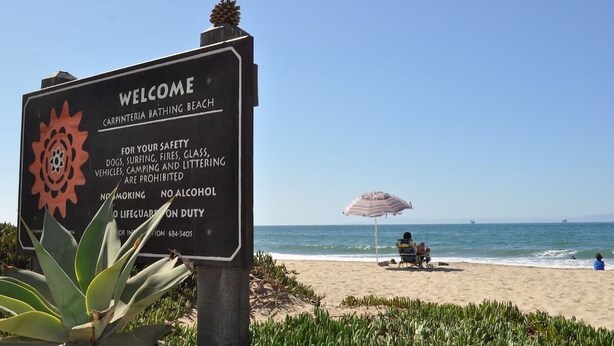 A welcome sign at Carpinteria Bathing Beach with safety rules and a lifeguard duty notice. - Sandyland Beach Studio Carpinteria (Carpinteria)