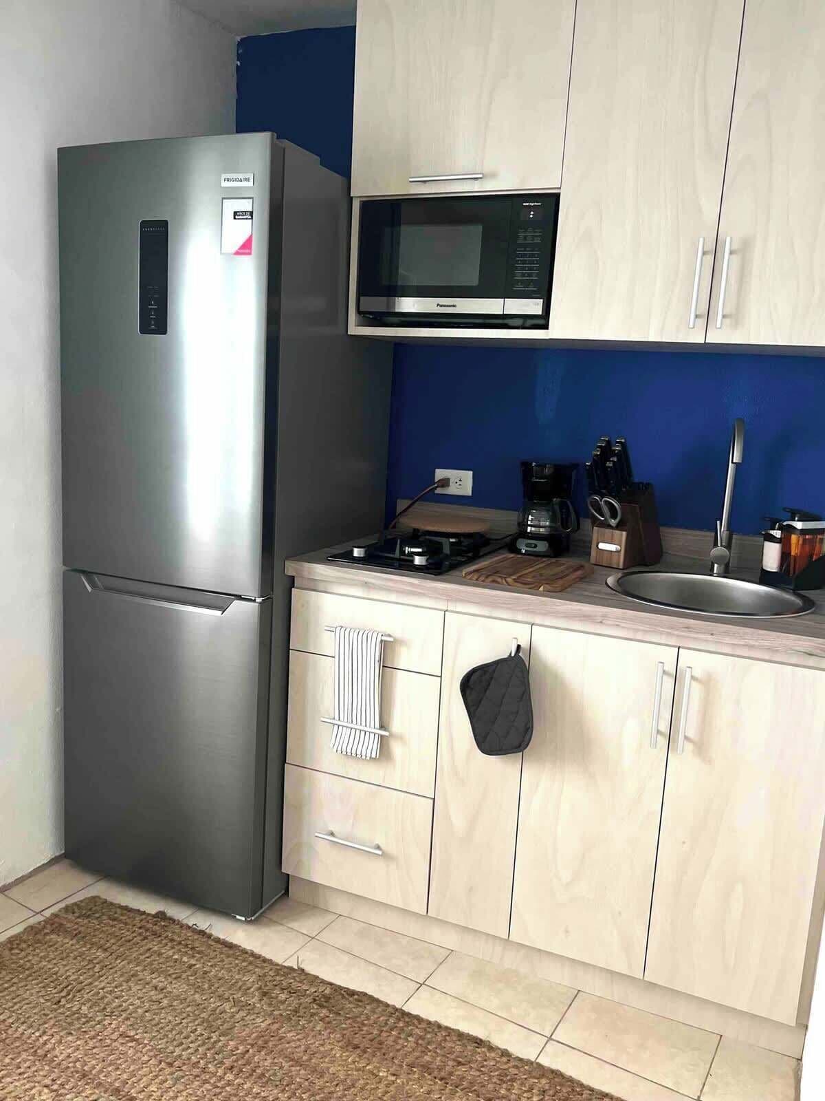Fridge, microwave, stovetop, coffee/tea maker