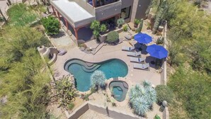 A modern two-story house with a swimming pool, outdoor seating, and desert landscaping. - Fabulous Luxury Home on Quiet 2 acres (Tucson)