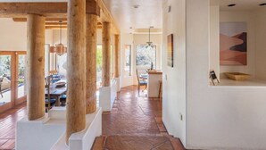 A spacious interior with a wooden column structure, a stone-tiled floor, and a view of the outdoors. - Fabulous Luxury Home on Quiet 2 acres (Tucson)