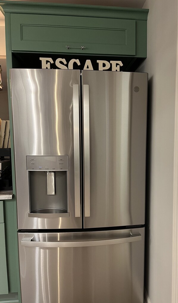 A stainless steel refrigerator with a water dispenser and a freezer compartment.