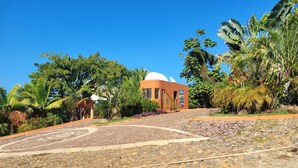 A building with a dome and a paved area with a stone pattern. - 1 Bedroom Condo with Incredible Ocean View in Nayarit Jungle #404 (El Divisadero)
