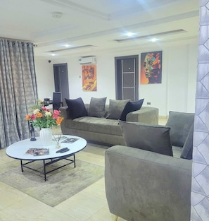 Business Apartment | Living area | 55-inch Smart TV with cable channels
