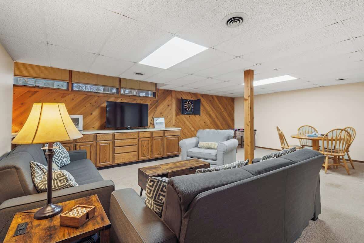 A modern living room with a sofa, a coffee table, a lamp, and a TV.