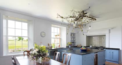 A luxuriously appointed farmhouse with excellent entertaining space for families and groups.