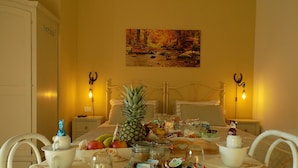A breakfast setup with a variety of fruits, pastries, and beverages on a table with a white tablecloth. - relais Cà del rio (Pianoro)