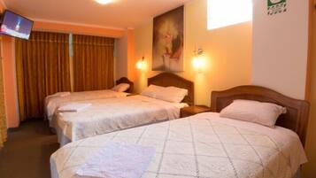 A hotel room with two beds, a TV on the left, and a painting on the wall.