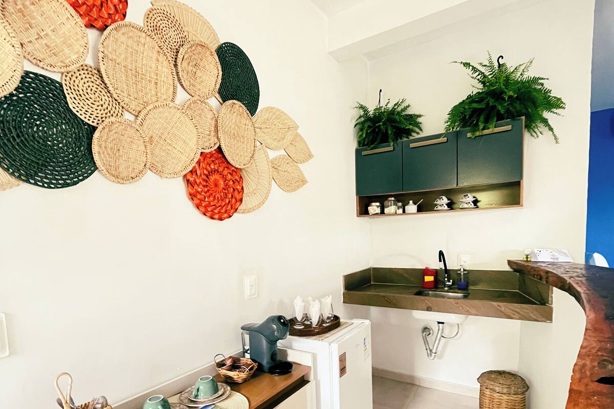 A modern kitchen with a white countertop, a built-in sink, and a wooden cabinet.