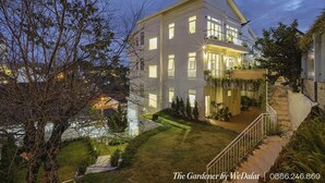 A modern two-story house with a well-maintained garden, a balcony, and a staircase leading to the entrance. - The Gardener by WeDalat (Xuan Huong - Da Lat)