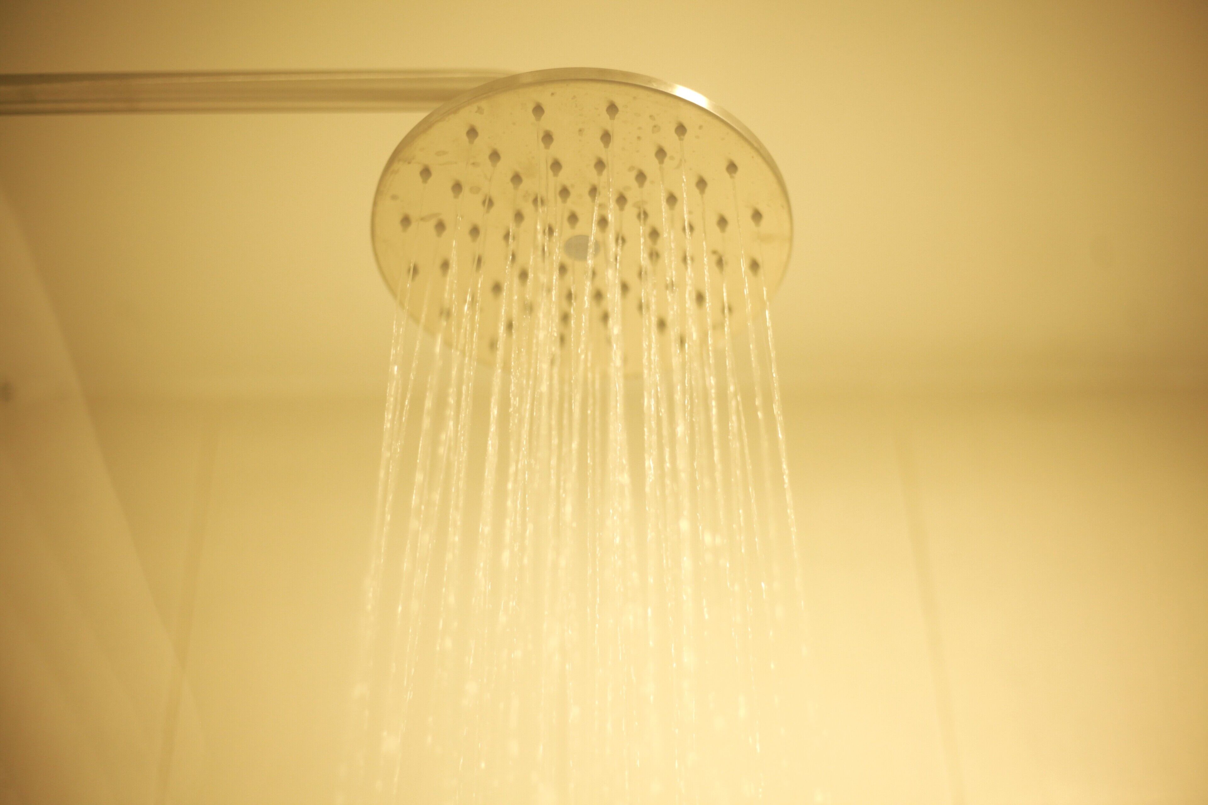 A showerhead with water flowing from it.