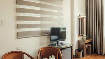 Deluxe Triple Room | Living area | 32-inch LED TV with cable channels