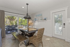 Enjoy meals in this dining area with a large table, woven chairs, and a bench.