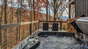 A hot tub on a wooden deck with a view of autumn trees. - Sunrise and Stardust - Hot Tub | Mountain Views | Screened Porch | (Morganton)