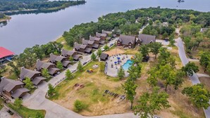 A lakeside resort with multiple cabins, a swimming pool, and a dock. - Lakefront Gem w/ Gorgeous Views, Boat Slip, Air Hockey & Close to Silver Dollar City (Branson)