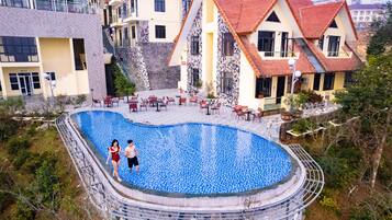 Relax in the courtyard, surrounded by a unique pool with a mosaic tile design, and enjoy outdoor seating.