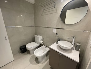 A modern bathroom with a toilet, bidet, and sink. - San Telmo Oasis Contemporary Luxurious Studios Num6863 (Buenos Aires)