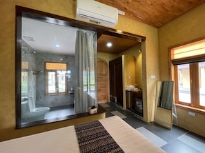 A modern bathroom with a large mirror, a shower, and a toilet. - Sky Bay Lodge (Ha Giang 1)