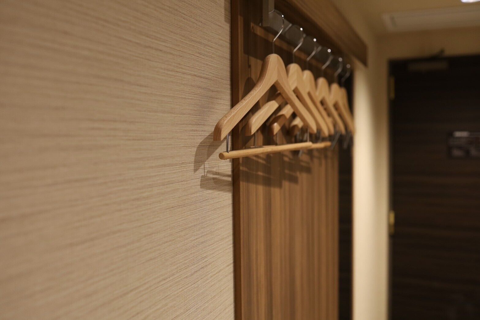 A wooden wall with a wooden hanger rack.
