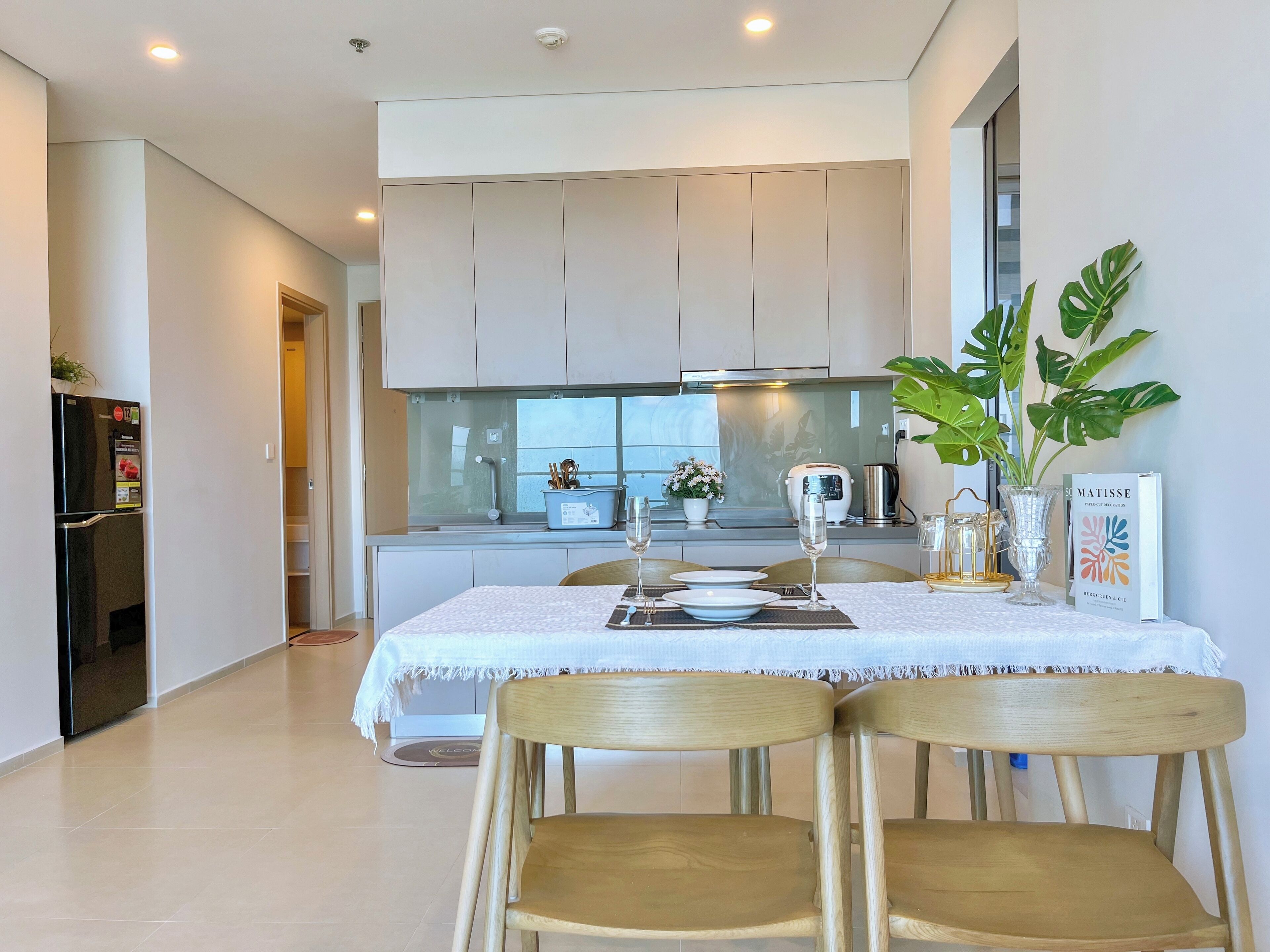 A modern kitchen with a dining area.