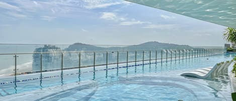Outdoor pool, open 6:00 AM to 9:00 PM, pool loungers, lifeguards on site