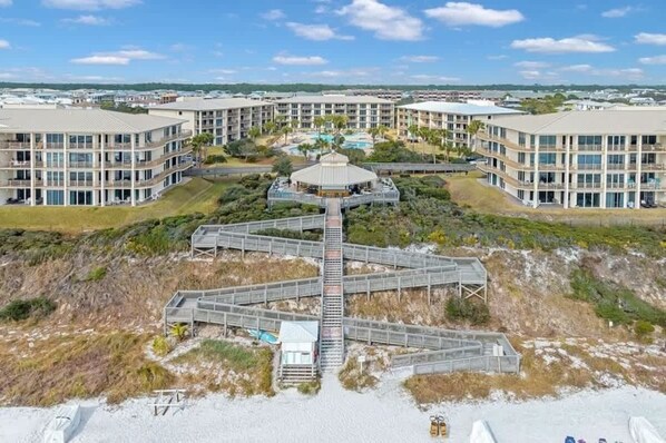 A hotel with a central courtyard, multiple balconies, and a pool.
