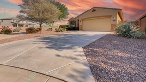A residential driveway leading to a house with a garage, surrounded by landscaped areas and a tree. - Perfect Retreat! 30 Nights Min! Raised Hot Tub With Views! (San Tan Valley)