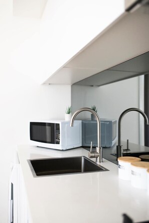 Fridge, microwave, oven, stovetop - The Elm Apartments | The Yellow Room (Orange)