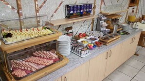 A buffet setup with various food items and condiments.